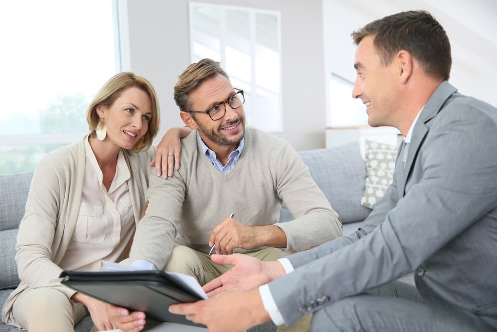 Couple with realtor signing mortgage contract-2